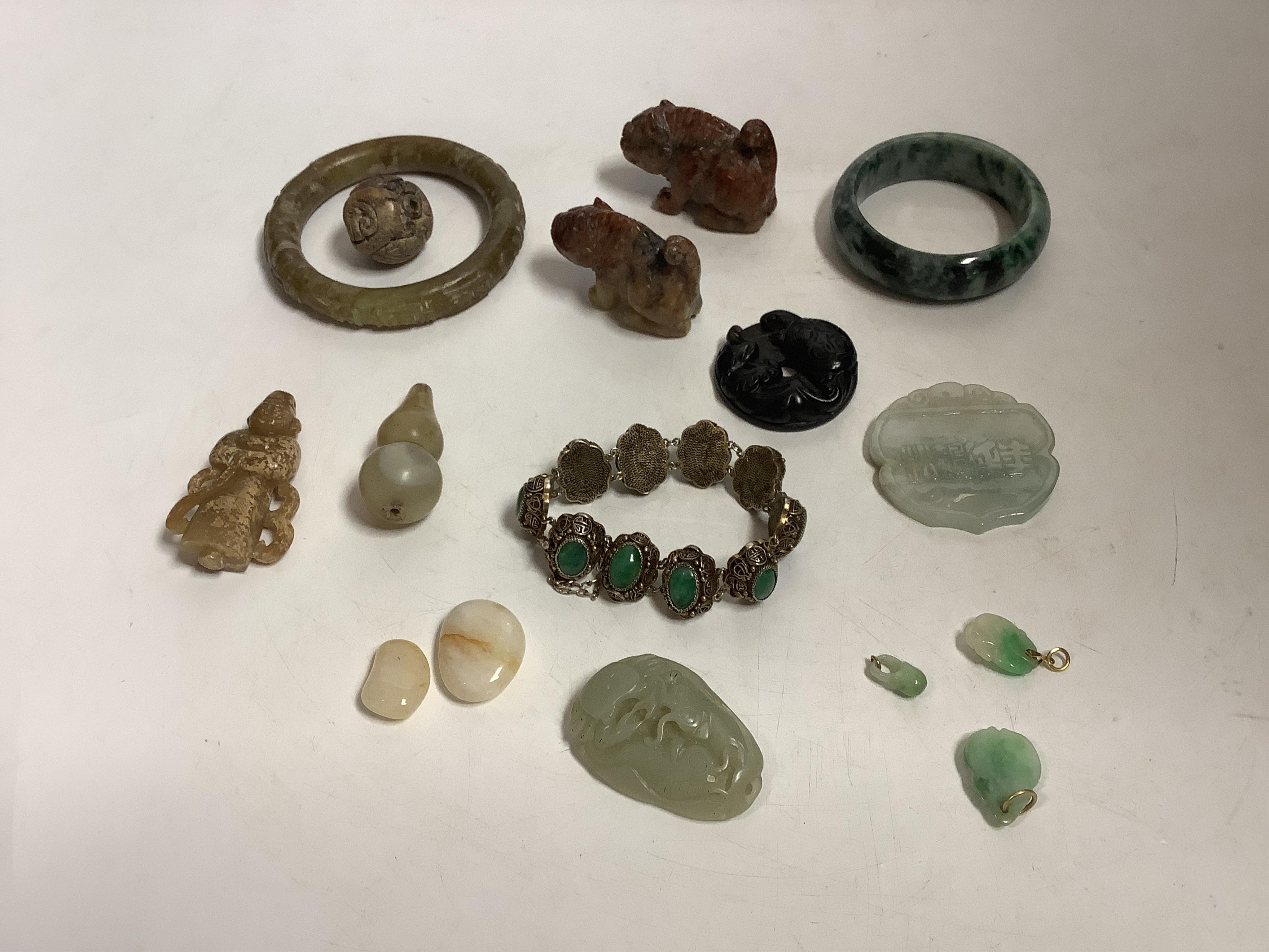 Sixteen Chinese jade and hardstone carvings, including a gilded white metal and jadeite bracelet, three pendants etc. Condition - fair